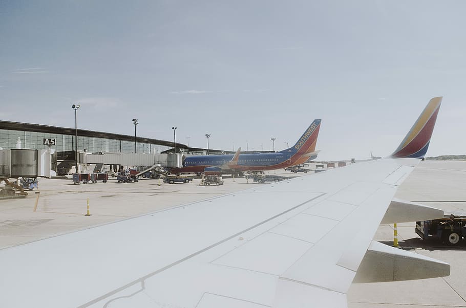 HD wallpaper: passenger planes on airport at daytime, blue and red