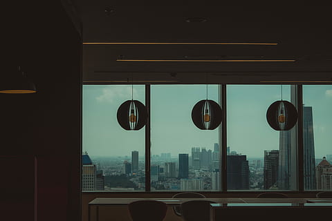 low-light photo of high-rise buildings, three gray pendant lamps hanged near glass wall HD wallpaper
