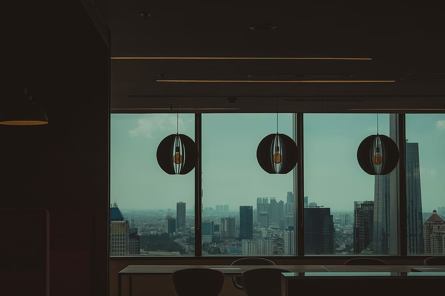 low-light photo of high-rise buildings, three gray pendant lamps hanged near glass wall HD wallpaper