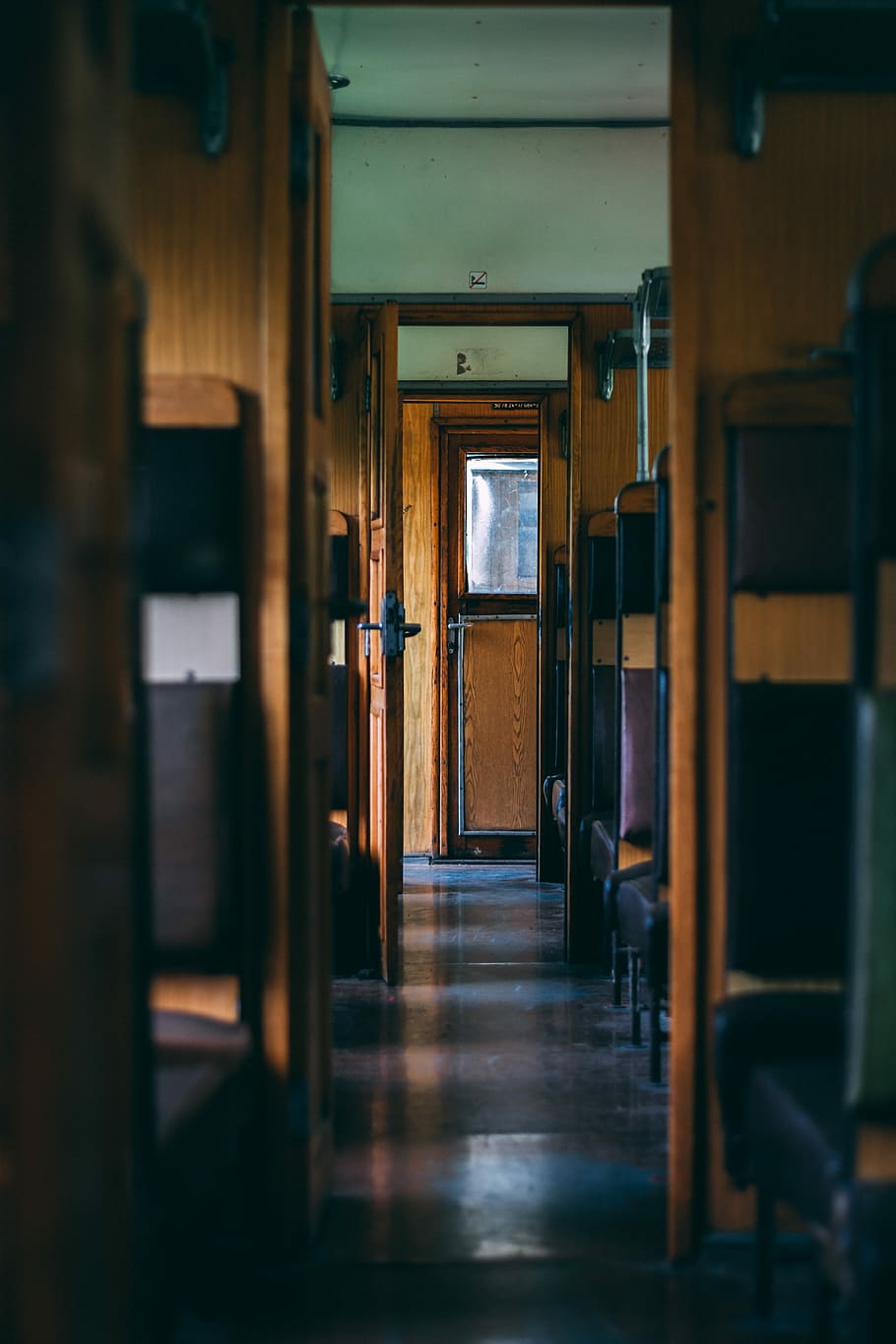 interior of train, pathway in the middle of brown and purple wooden chairs HD wallpaper