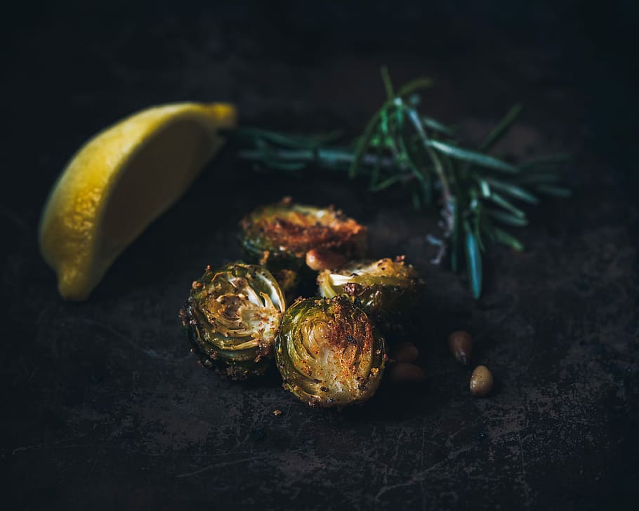 selective focus photography of grilled Brussels sprout, lemon wedge, and rosemary sprig, brussel sprouts beside sliced lemon HD wallpaper