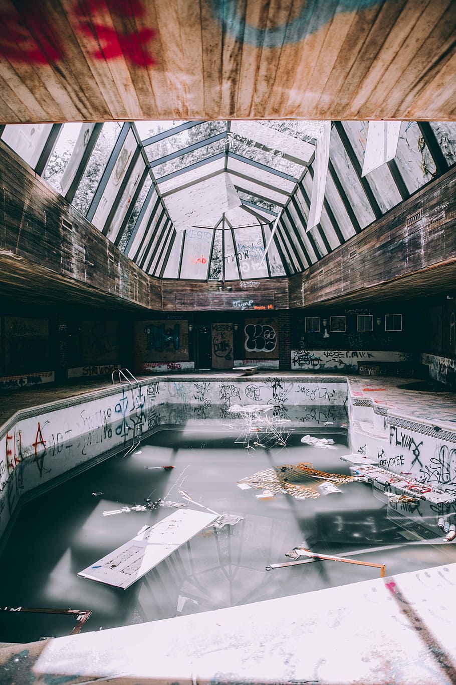 almost empty swimming pool, graffiti, abandoned, indoor, structure
