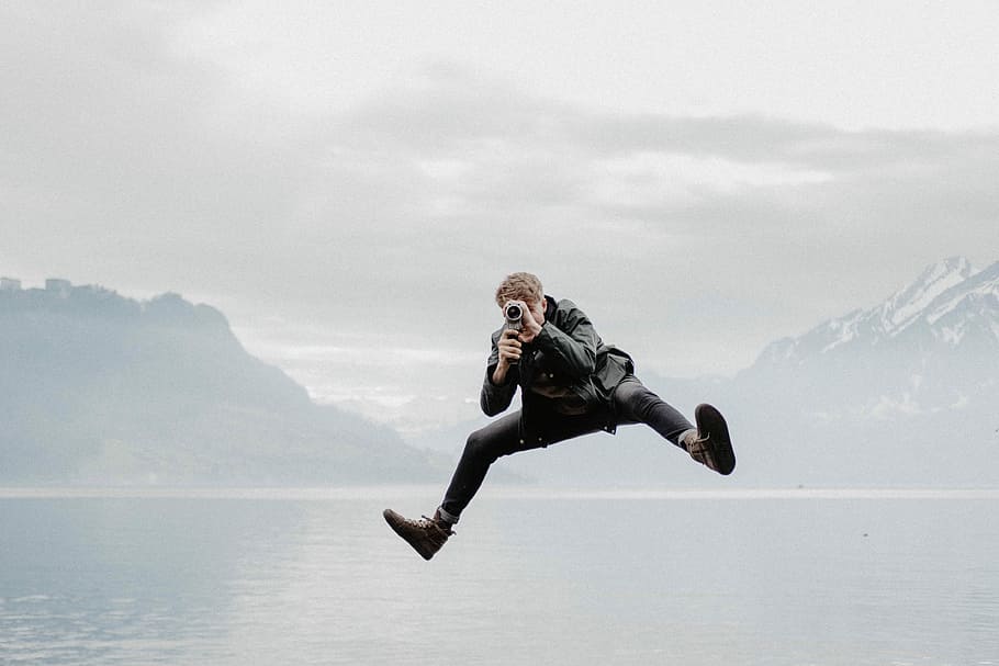 the Camera Jump II, man on flight, jumping, mountian, water, one person HD wallpaper