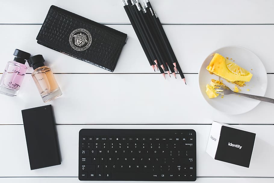 Top view of desk with copy space, cake, keyboard, office, pencils HD wallpaper