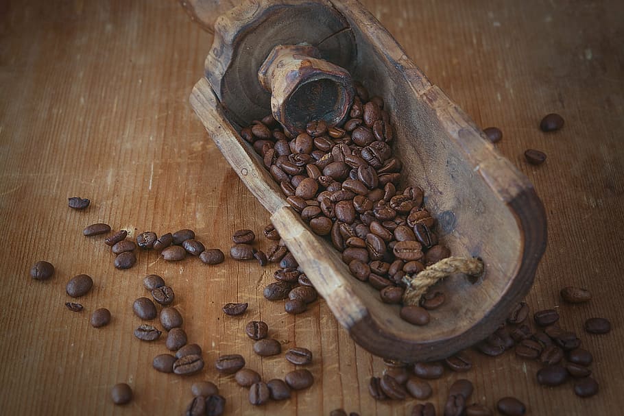 flat lay photography of brown coffee beans on brown table, roasted