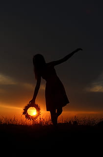 silhouette photography of woman surrounded by grass during golden hour HD wallpaper