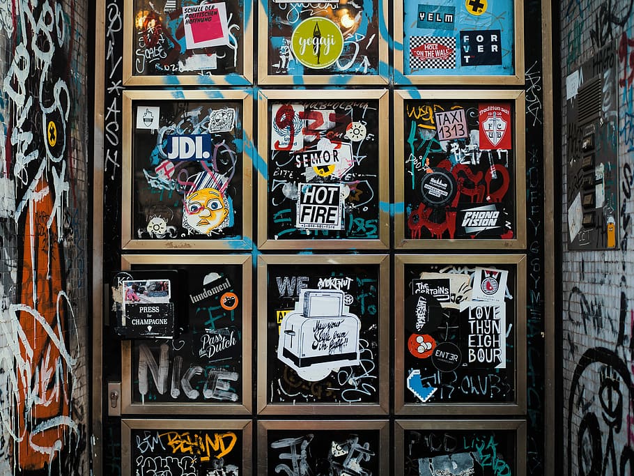 grafiti wall art, sign, window, sticker, city, street, choice