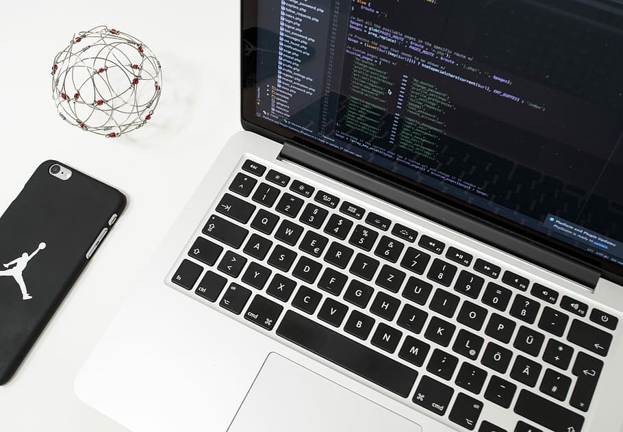 white laptop computer on table, MacBook Pro beside silver iPhone 6 with black case HD wallpaper
