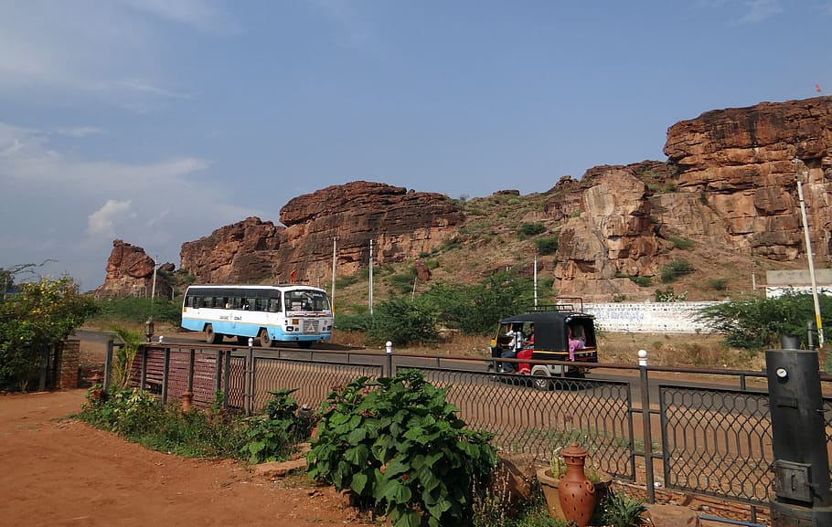 badami, rocks, sand stone, red, cliff, road, bus, india, mountain HD wallpaper