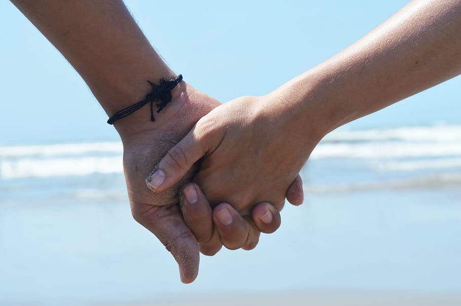photo of holding hands near seashore, love, beach, mar, water HD wallpaper