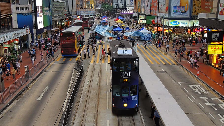 blue and black double decker bus on middle of road, hongkong