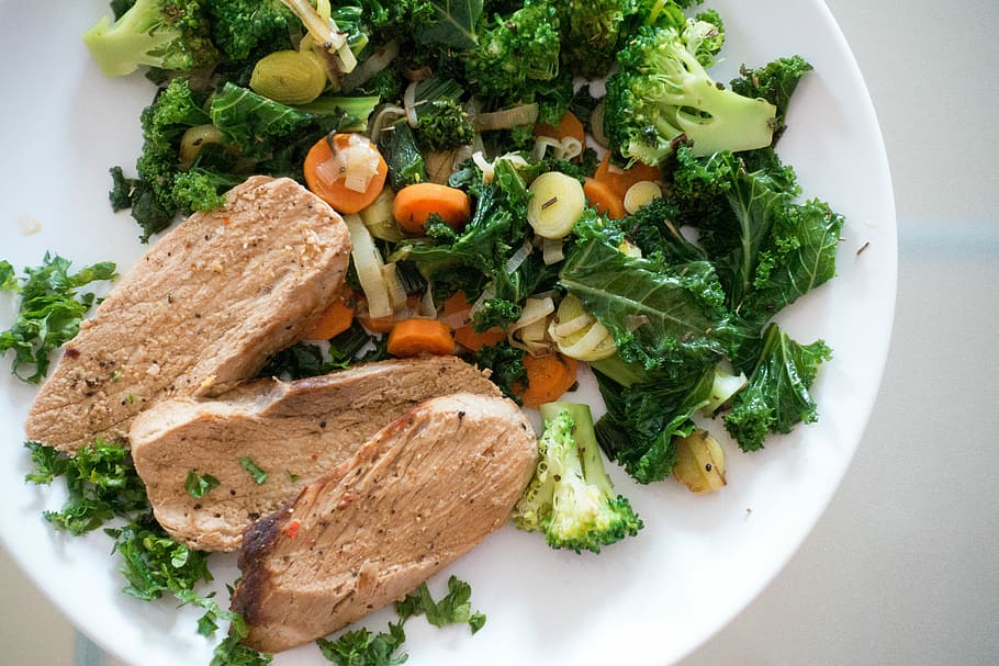 Pork meat with green vegetables, broccoli, healthy, kale, paleo