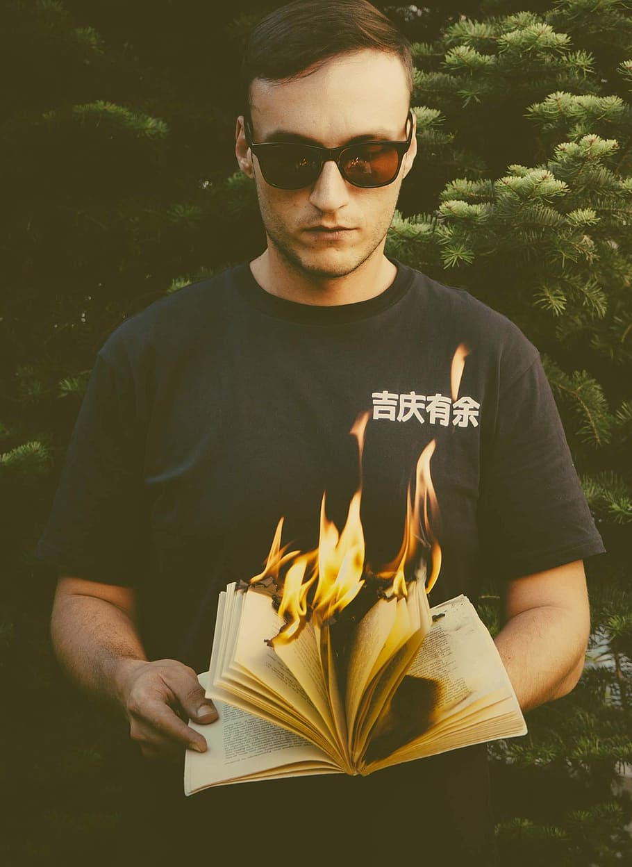 man standing while holding burning book, man holding burning book HD wallpaper
