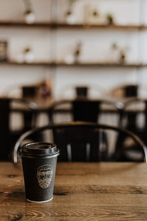 black disposable coffee cup on wooden table, black disposable coffee cup HD wallpaper