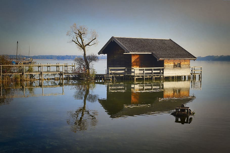brown wooden house on body of water under white clouds, chiemsee HD wallpaper