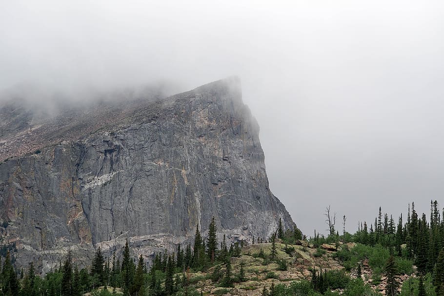 mountain covered by fog, gray stone mountain cliff with fog, person HD wallpaper