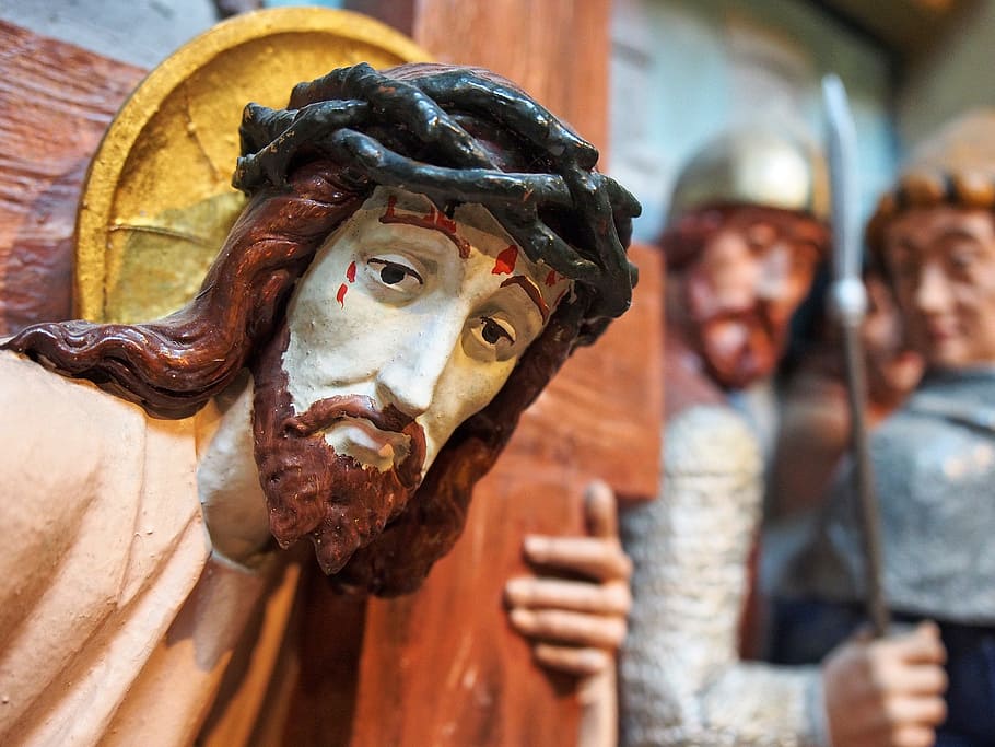 shallow depth of field photo of Jesus Christ figurine, cross