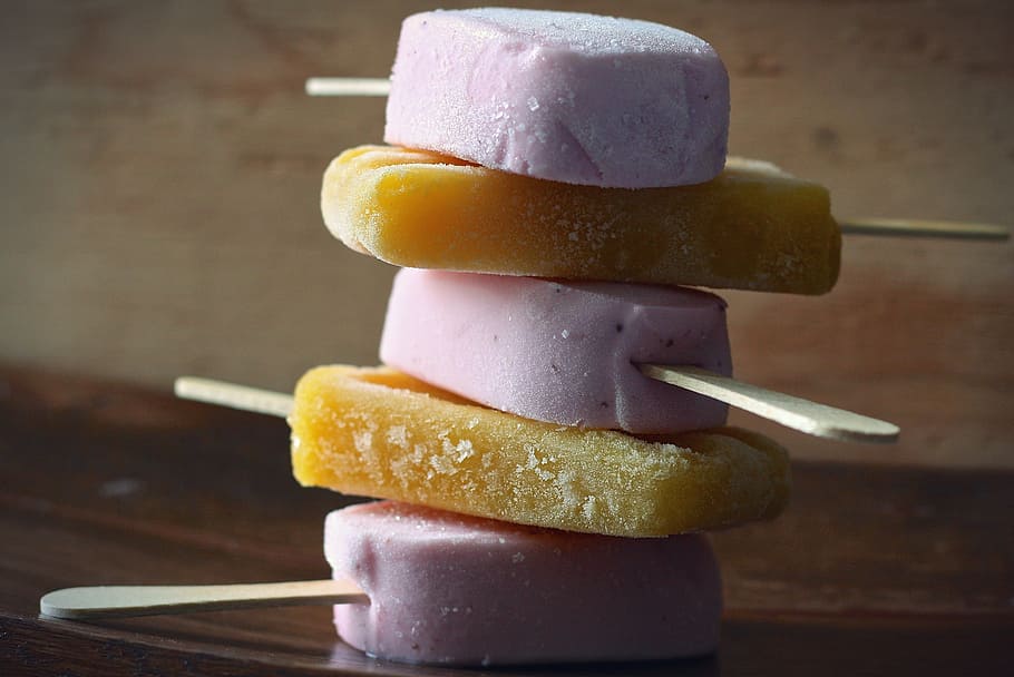 stack of pink and brown popsicles, mango, strawberry, ice cream