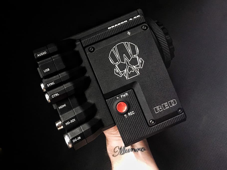 black and gray amplfier, person holding black red dot scope, button HD wallpaper