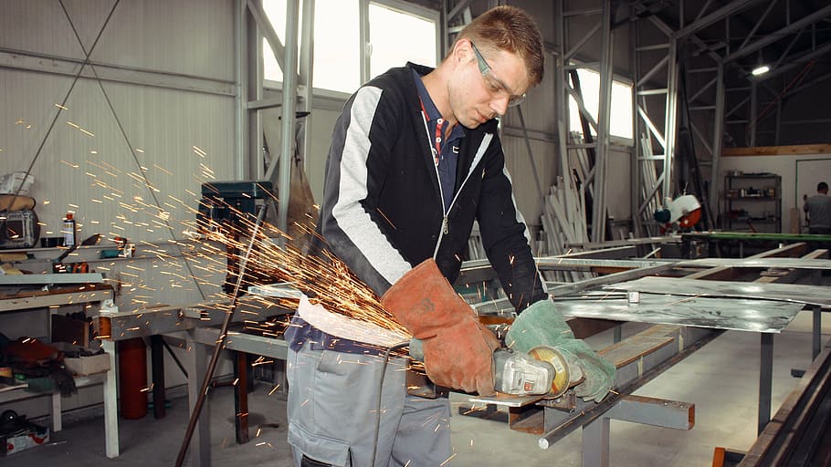 man welding metal frame during daytime, master, worker, grinder