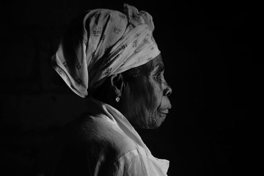 photo of woman with headwrap and white top with black background portrait HD wallpaper