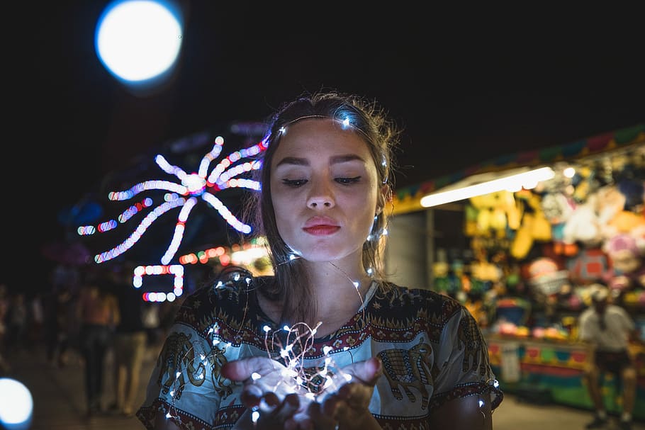 woman wearing multicolored shirt holding lighted string lights, woman holding minilights, HD wallpaper