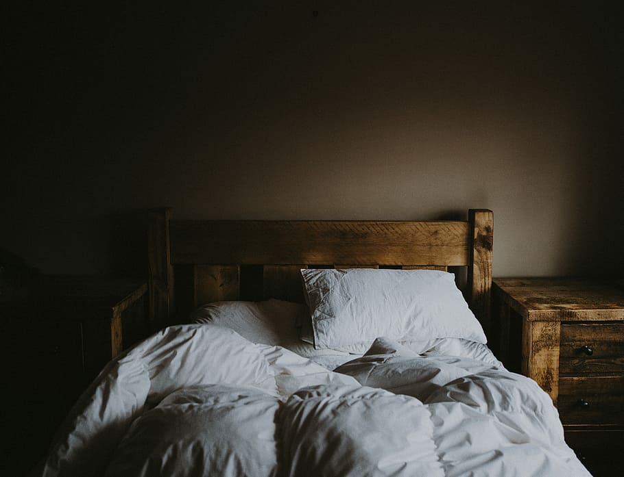 white bed comforter set and brown wooden bed frame beside brown wooden nightstand, white bedding set and brown wooden bed frame with low light photo HD wallpaper