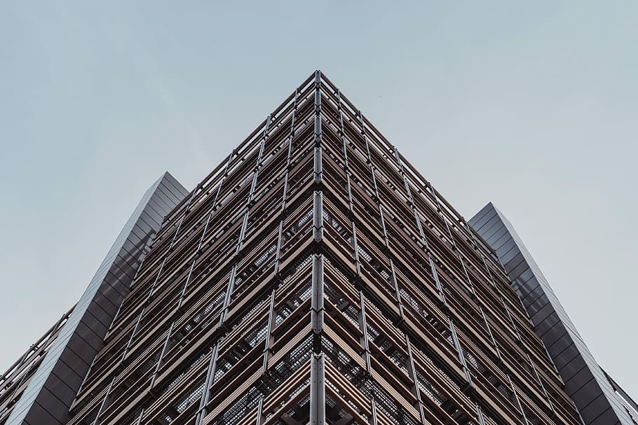 brown and gray steel building, low angle photo of brown concrete building during daytime HD wallpaper