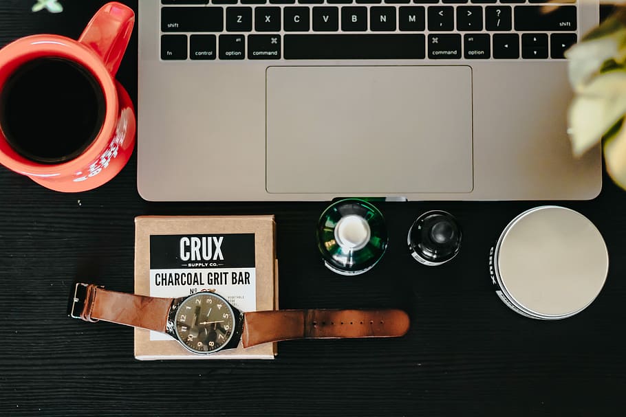 round watch near laptop computer, green glass bottle beside laptop HD wallpaper