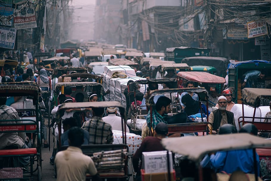 people riding auto rickshaws on street, people riding auto rickshaws during daytime