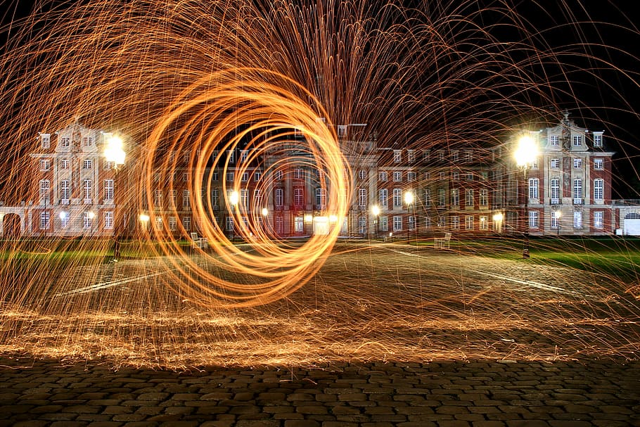 steel wool photography in front of red concrete building, light HD wallpaper