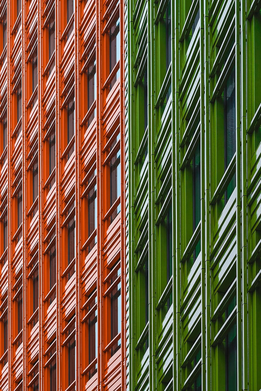 green and red architectural structure, photo of green and orange high rise building at daytime HD wallpaper