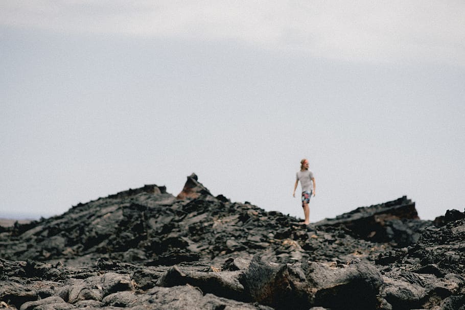 person walking on rocks, person walking on gray rock surface HD wallpaper