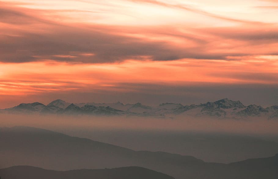 silhouette of mountains over cloudy sky during sunset, mountain covered by fogs during golden hour HD wallpaper