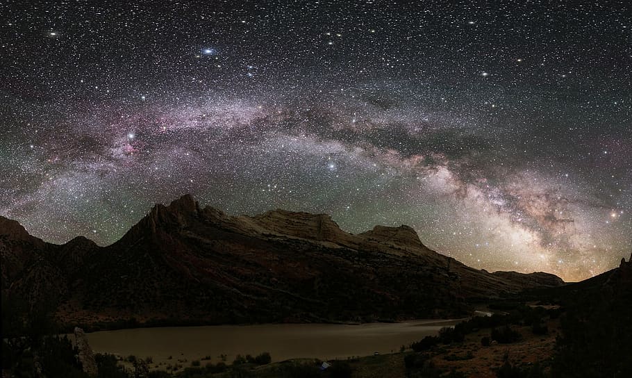 photo of mountains near lake, night sky, milky way, stars, cosmos
