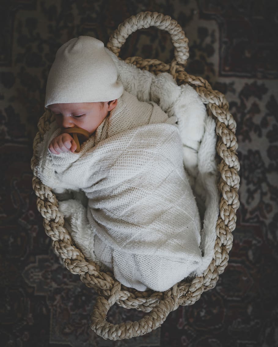 baby sleeping on basket, newborn, blanket, hat, one person, clothing