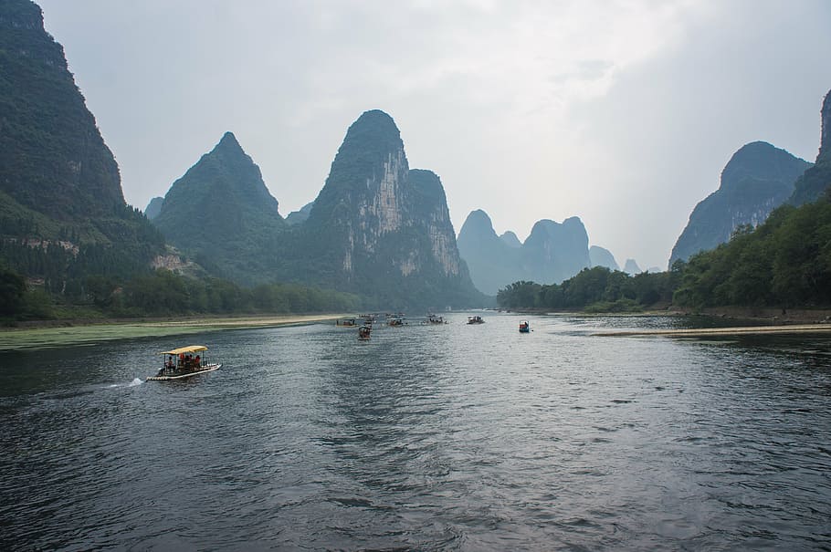 brown boat on body of water, china, giulin, yangshuo, li River