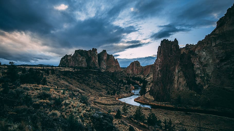 canyon under nimbus clouds, brown rocky mountains under blue cloudy sky during daytime HD wallpaper