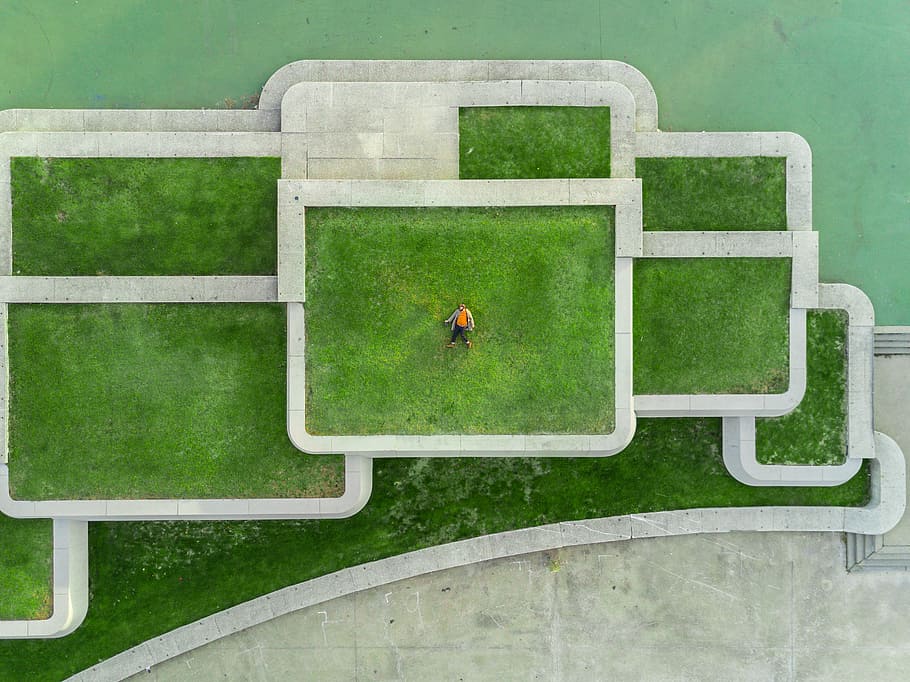 bird's eyeview photo of person lying on green grass, aerial photography of man lying on lawn HD wallpaper