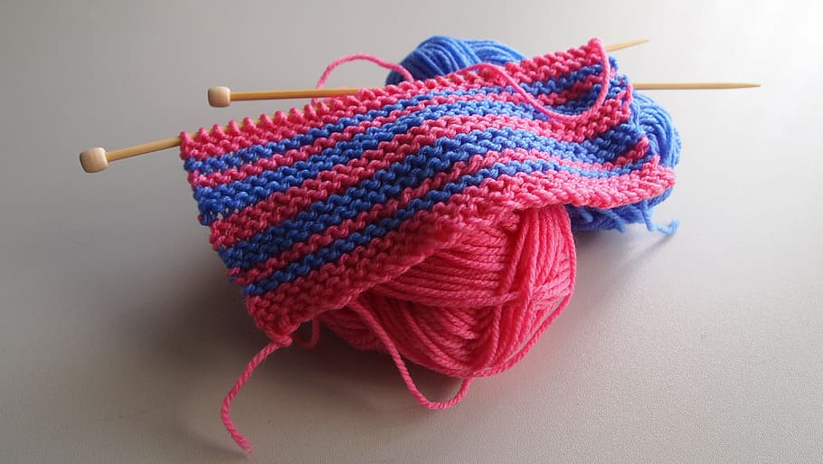 pink and blue knitted yarns with stitching needles on to of white flooring HD wallpaper