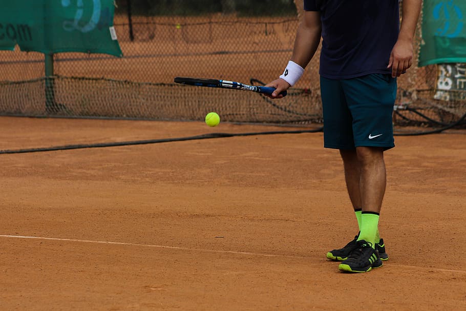 man holding tennis racket and tennis ball, tennis player, tennis dribble