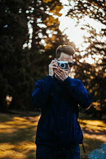 man taking photo, selective focus photography of man using MILC HD wallpaper