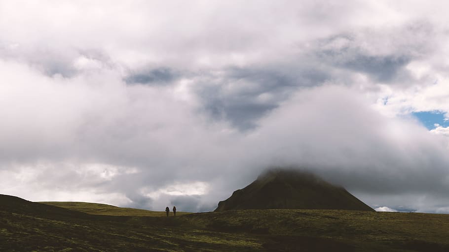 two person walking through mountain under clouds formation, two persons on green grass under white clouyds HD wallpaper