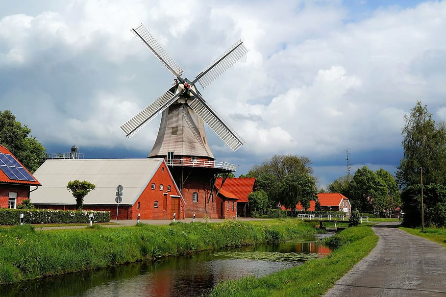 red and white house beside windmill near road during daytime HD wallpaper
