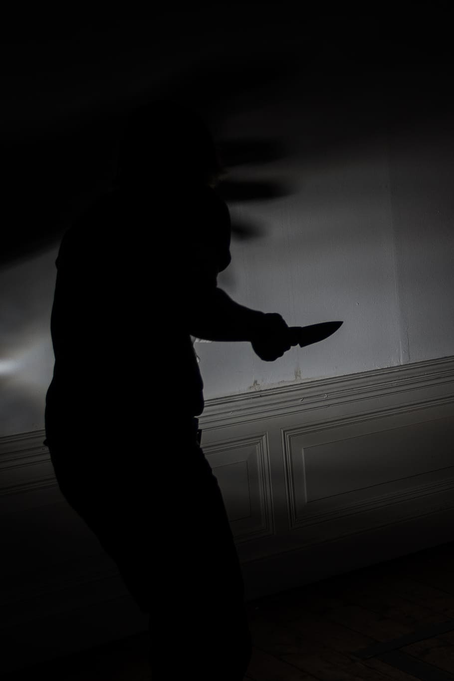 photograph of silhouette person holding a knife, murder, fear
