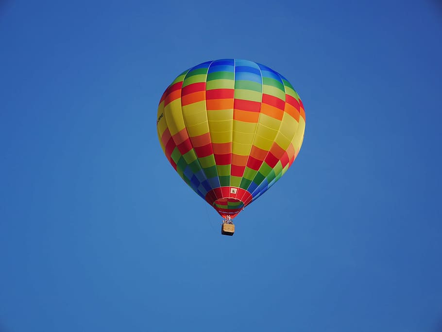 yellow, red, and blue hot air balloon soaring in sky, azure, raindrop