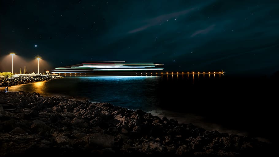 landscape photography of a cruise ship during nighttime, building near body of water during nittime HD wallpaper