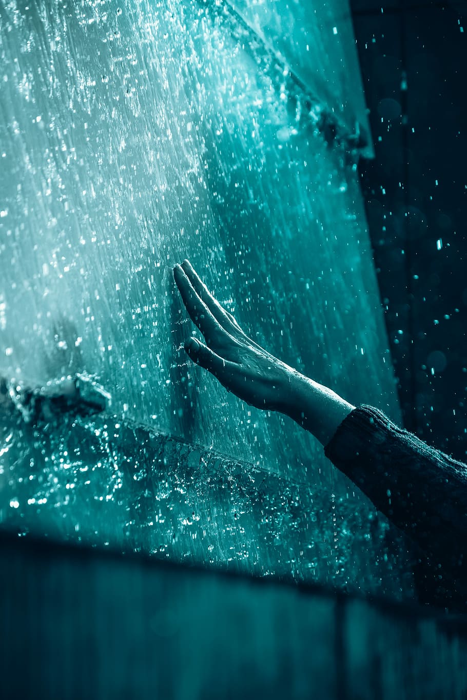 person touching the wall, person retching dew water on wall during nighttime HD wallpaper