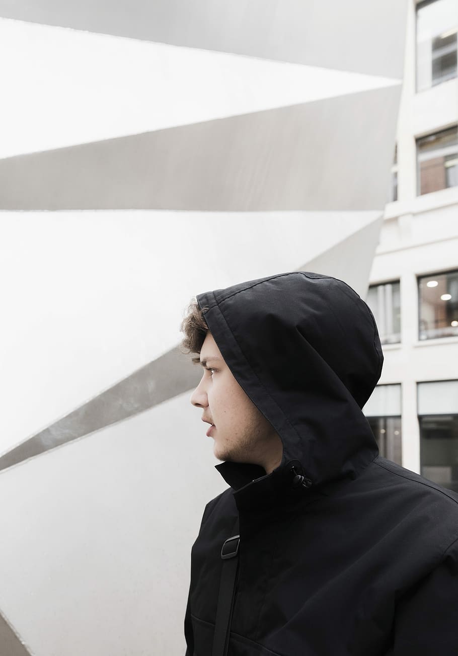 man in black hoodie during day time, man in black hoodie standing near building wall during daytime, HD wallpaper