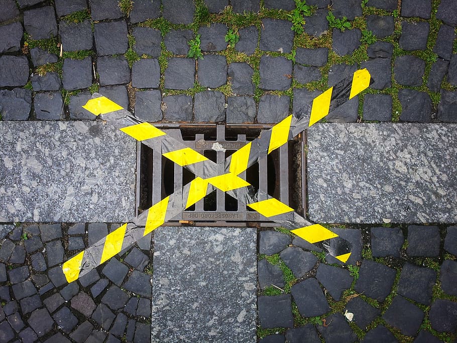 gully, locked, tape, ground, asphalt, road, yellow, day, high angle view